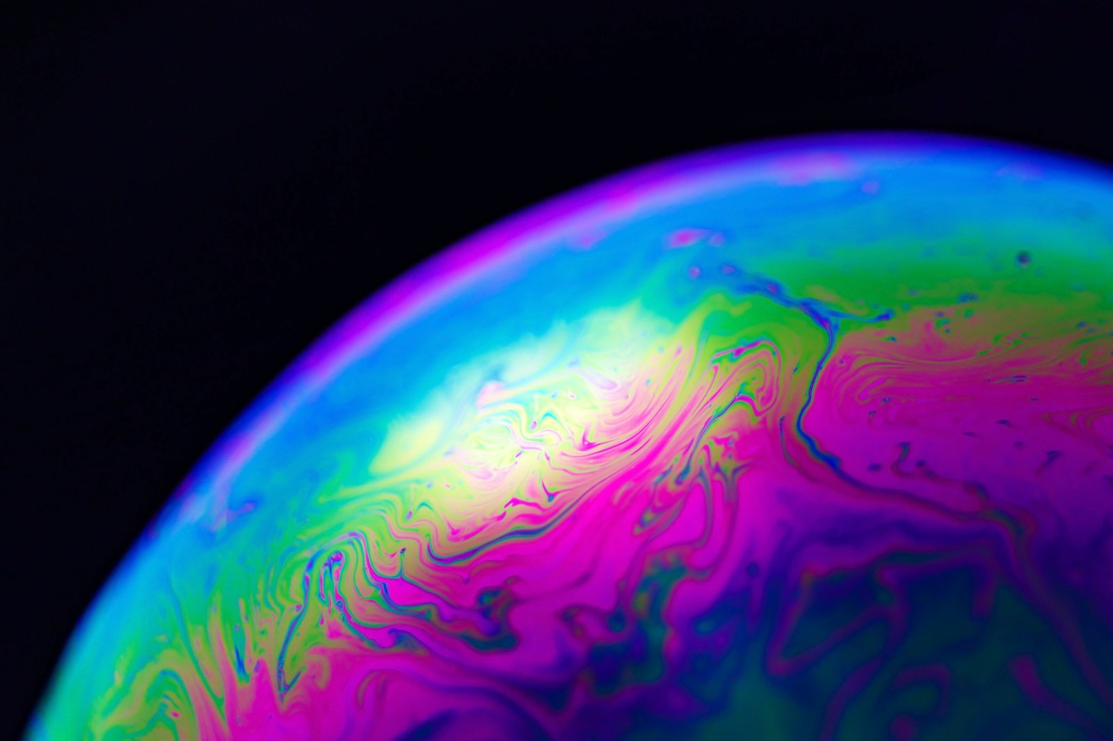 rainbow-soap-bubble-on-a-black-background-close-up-of-a-colorful-surface-.jpg